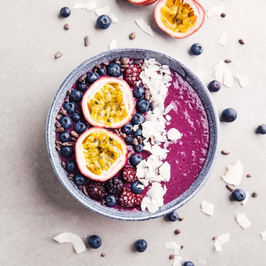 acai smoothie bowl with other fruits and berries on top