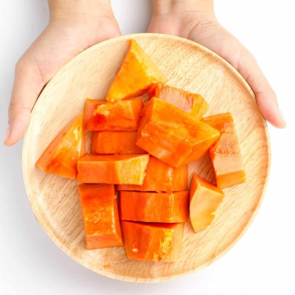 diced papaya on a bamboo plate