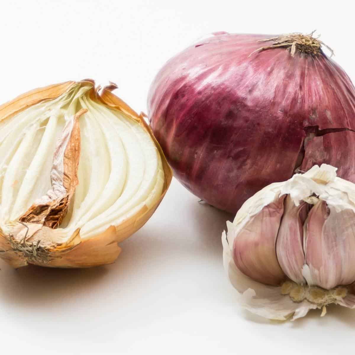 cut open onions and a garlic clove