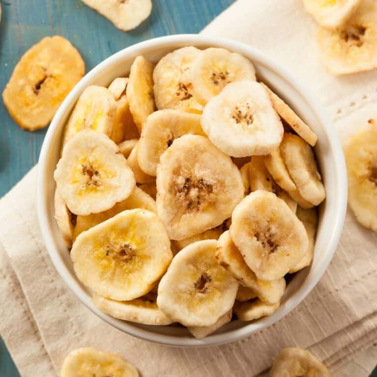 homemade banana chips in a bowl next to other banana chips