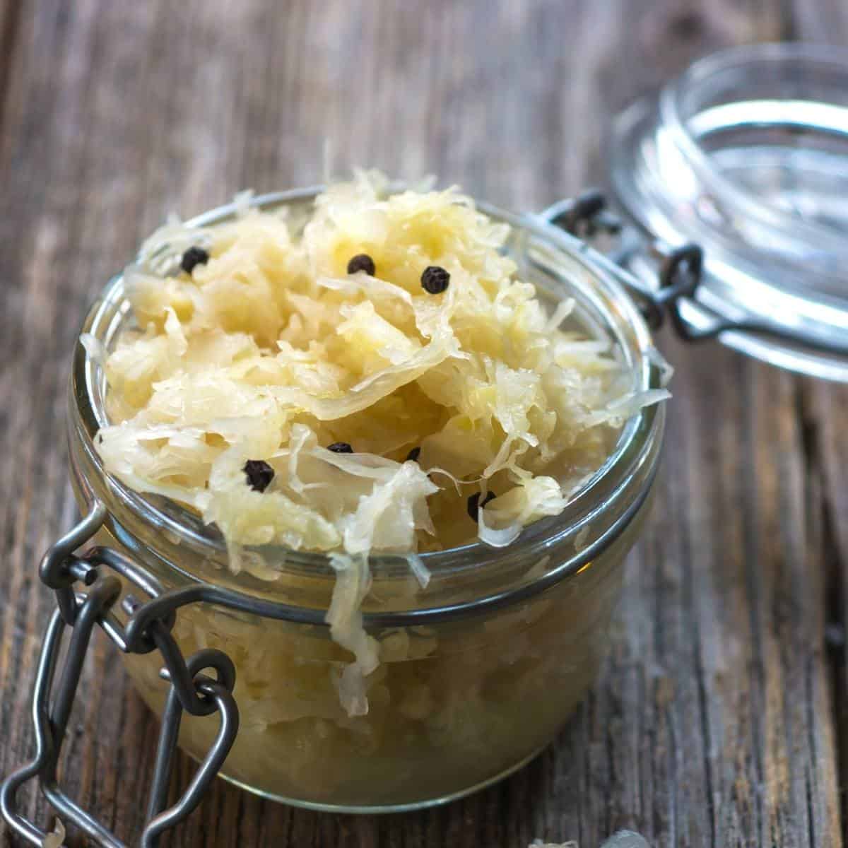 a homemade jar of sauerkraut with the lid open